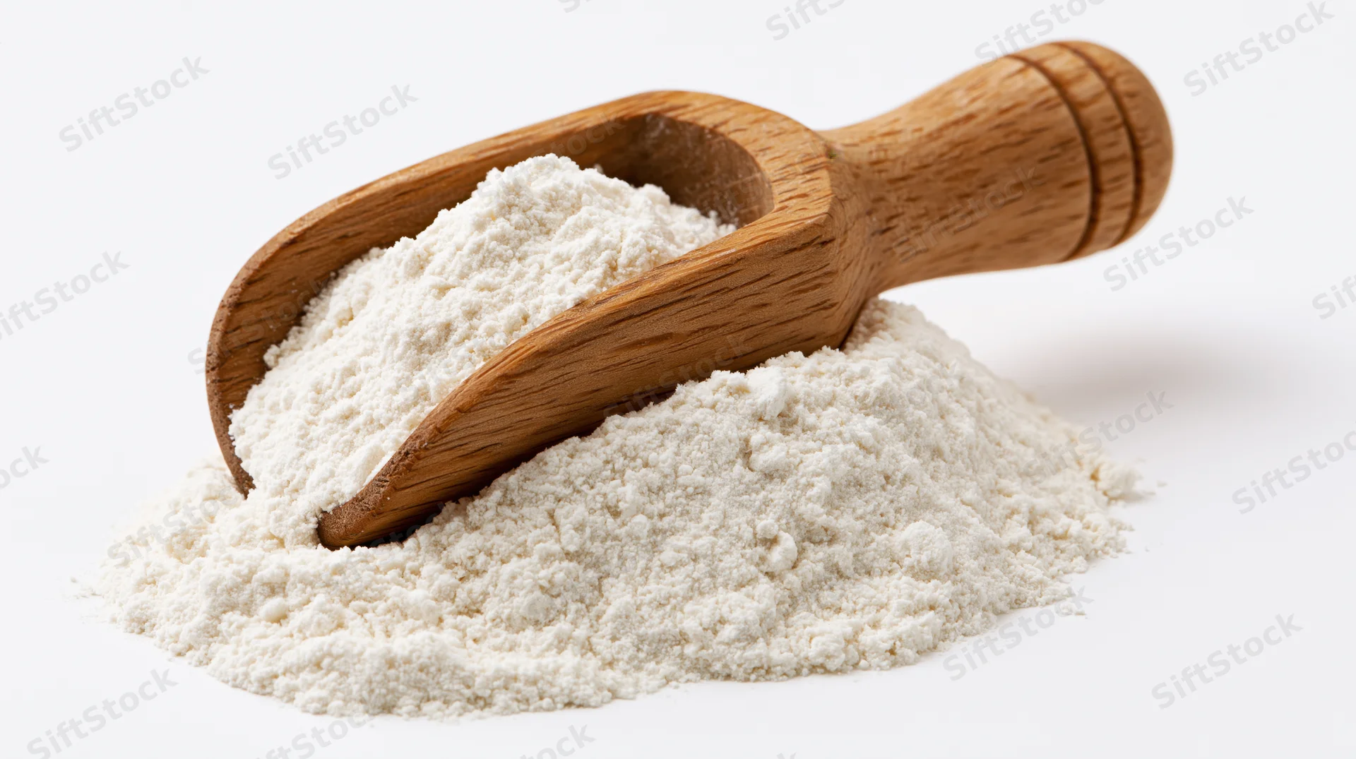 Wooden scoop resting on a mound of fine white flour against a white background