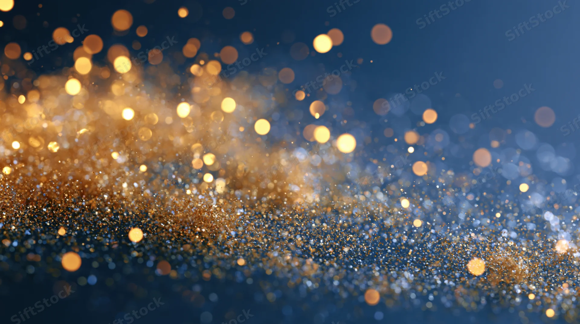 Golden bokeh lights shimmering across a dark blue abstract background with copyspace