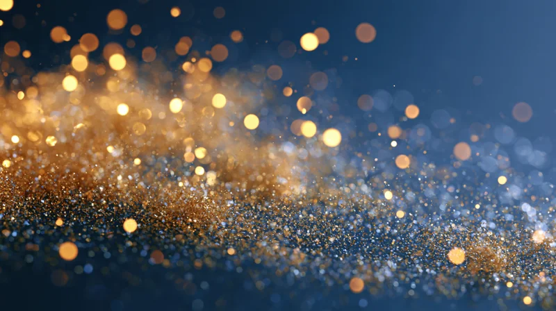 Golden bokeh lights shimmering across a dark blue abstract background with copyspace