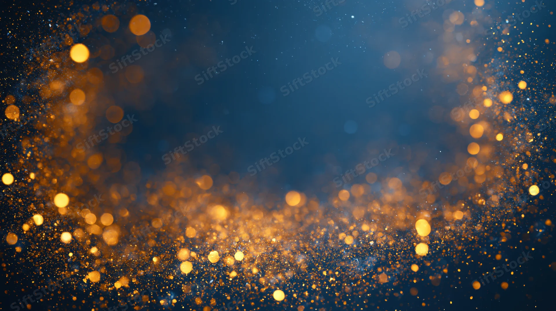 Golden bokeh lights scattered across a dark blue abstract background with copyspace in center