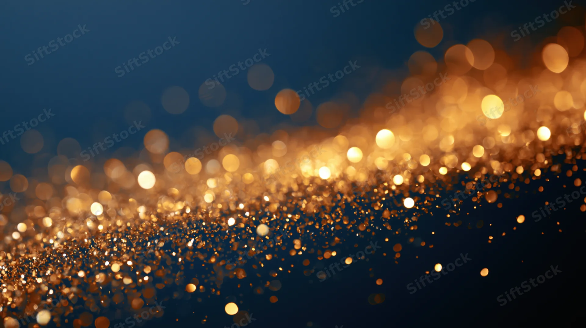 Golden bokeh lights scattered across a dark blue abstract background with soft glow and depth