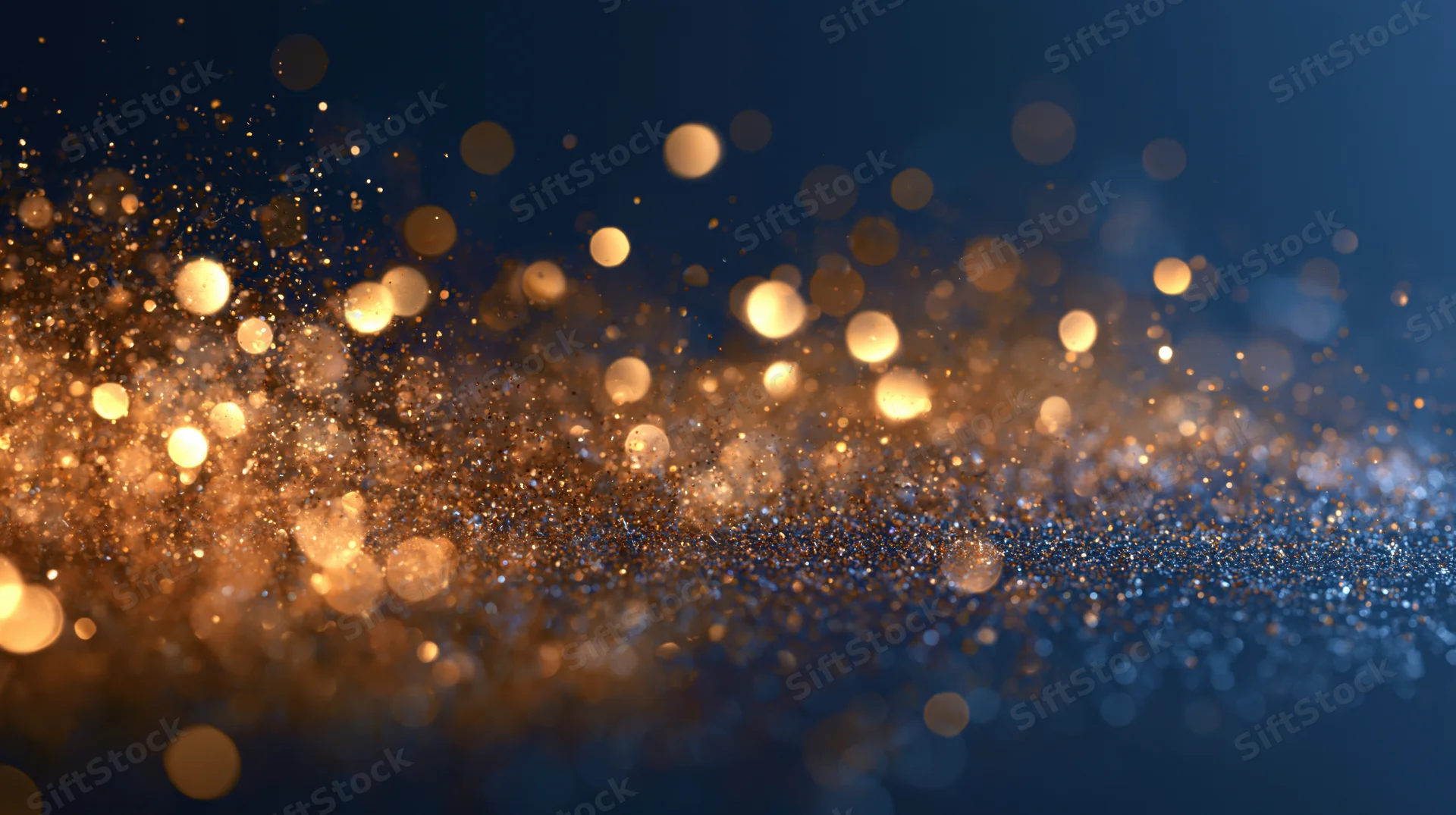 Golden bokeh lights scattered across a dark blue abstract background with soft glow and sparkle
