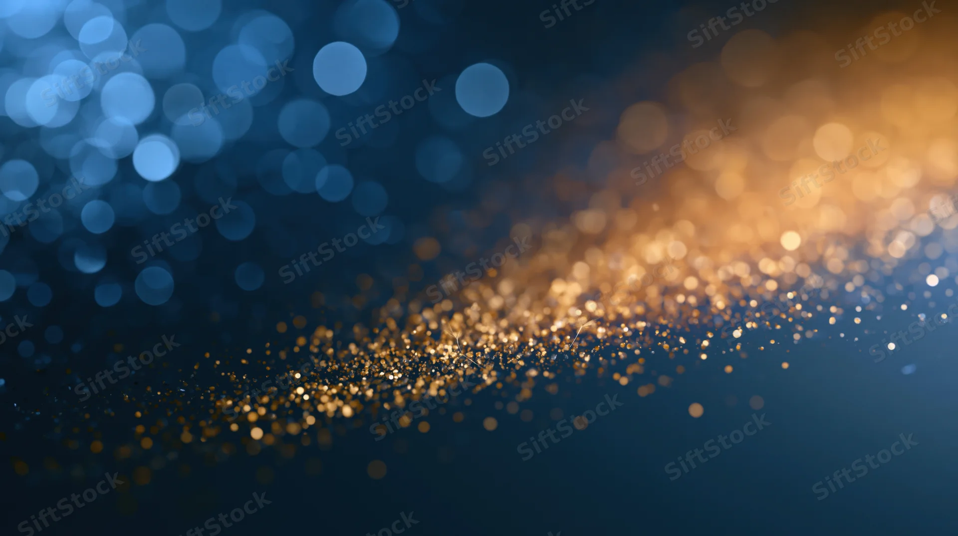 Abstract bokeh background with golden and blue out-of-focus lights forming a glowing trail across dark space