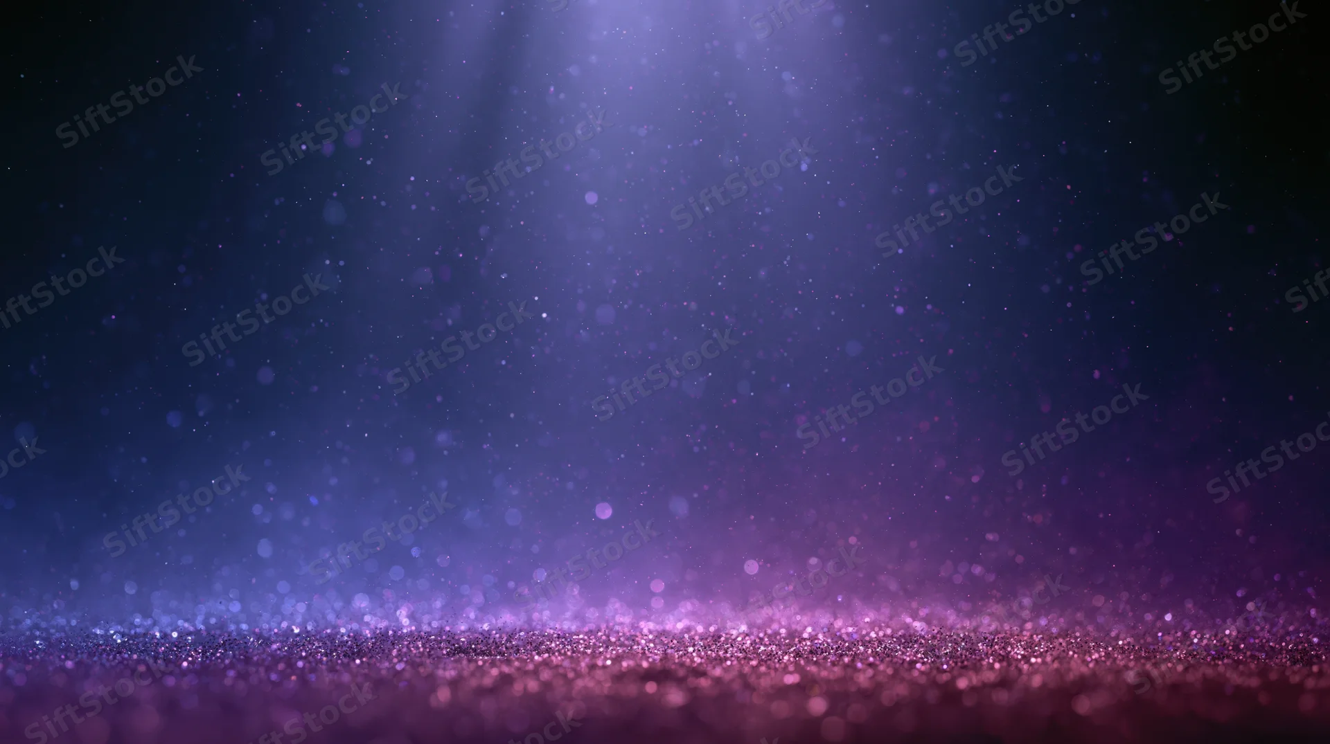 Abstract stage lighting with floating dust and glitter particles on a dark background