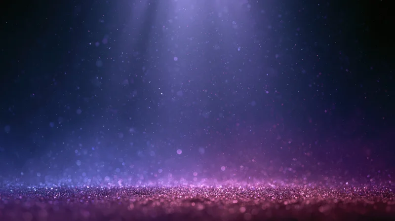 Abstract stage lighting with floating dust and glitter particles on a dark background