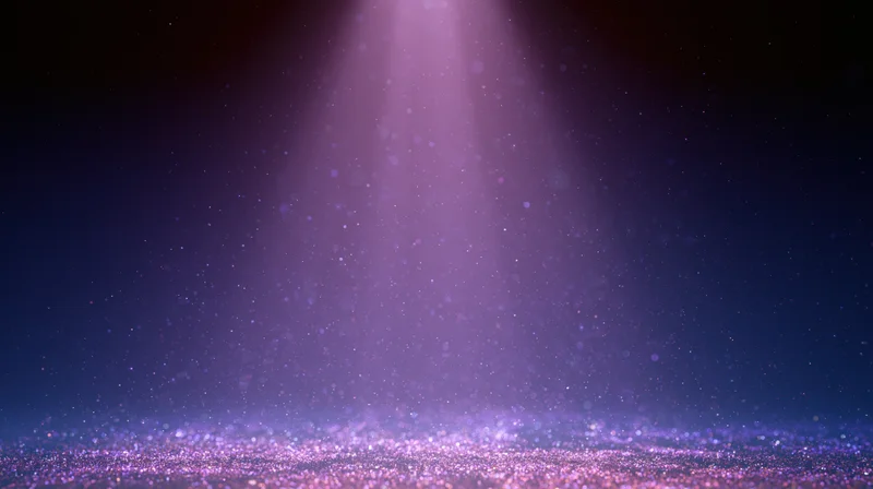 Purple spotlight beam illuminating floating dust particles on dark stage background