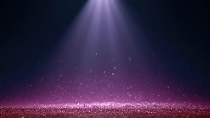 Spotlight beam illuminating glittering stage floor with floating dust particles in dark ambient setting