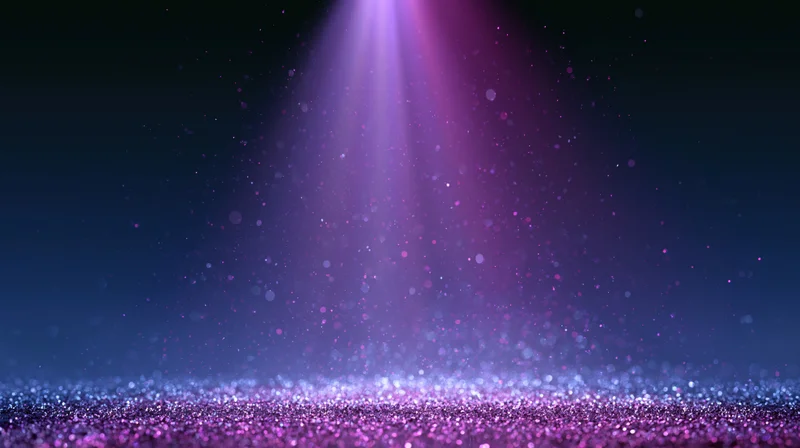Purple spotlight shining down on glittering stage floor with floating particles in dark space