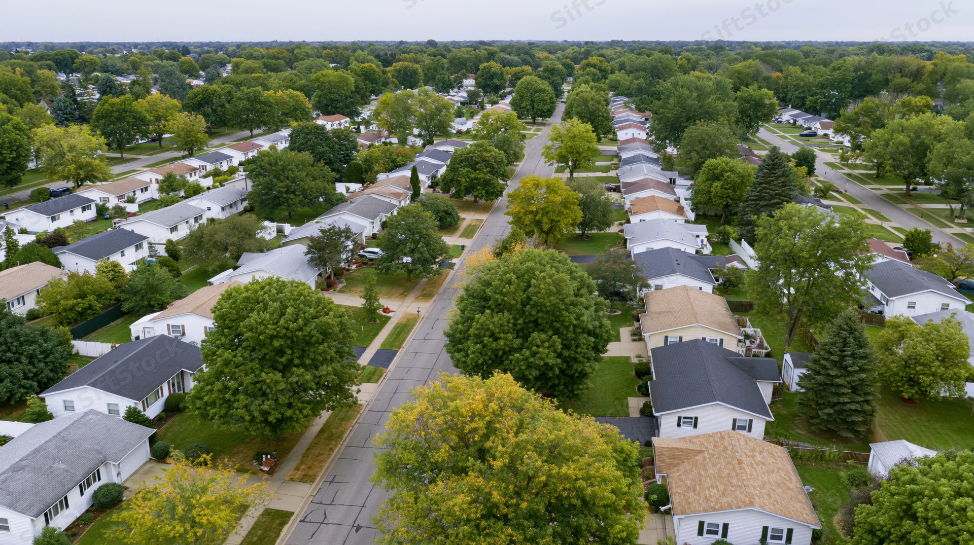 Aerial drone view of a suburban neighborhood with houses, trees, and streets in midwest america