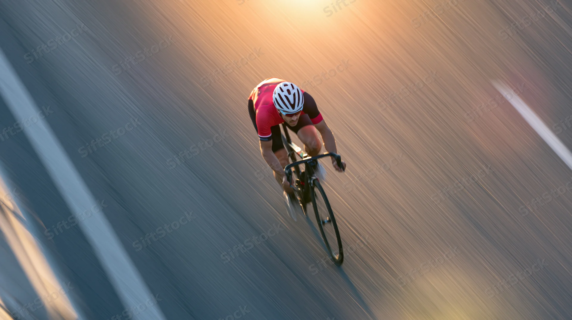 Overhead view of a cyclist sprinting on a road at speed