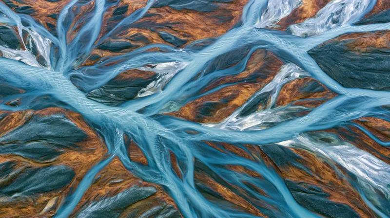 Aerial view of a braided glacial river delta flowing over rocky terrain