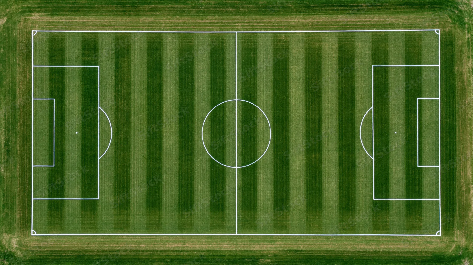 Aerial top-down view of a striped grass soccer field with white markings