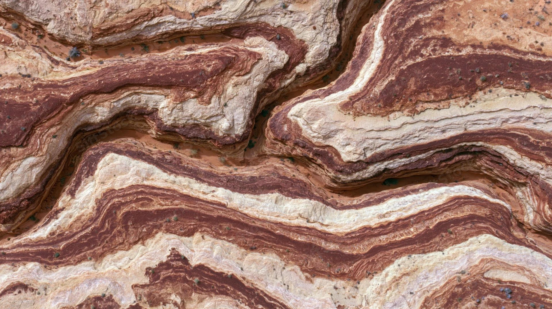 Aerial view of layered rock formations in a desert canyon