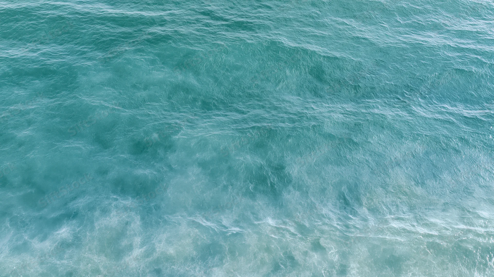 Aerial top-down view of open ocean surface with gentle ripple