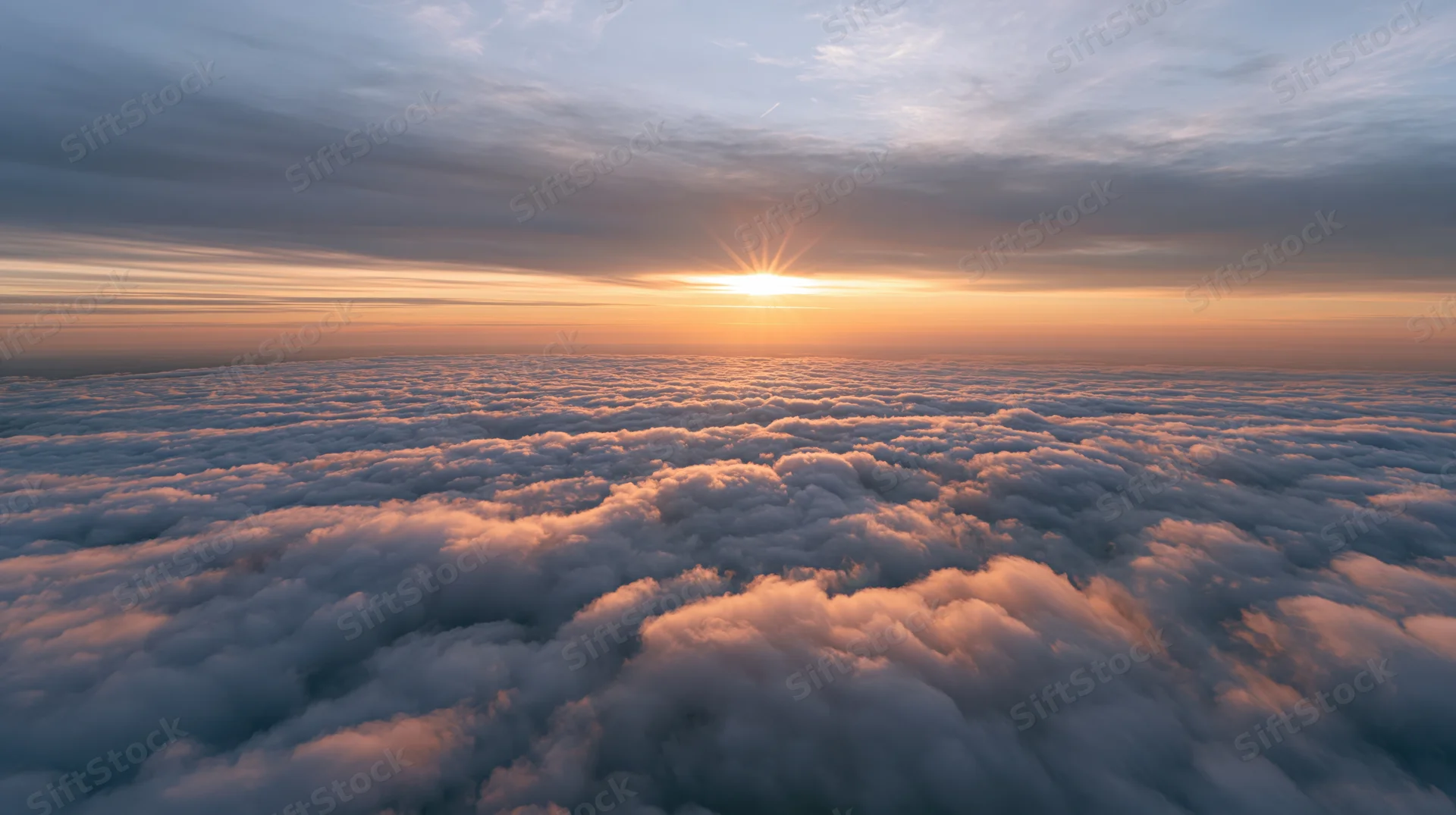 Aerial view of dense clouds at sunset above the horizon