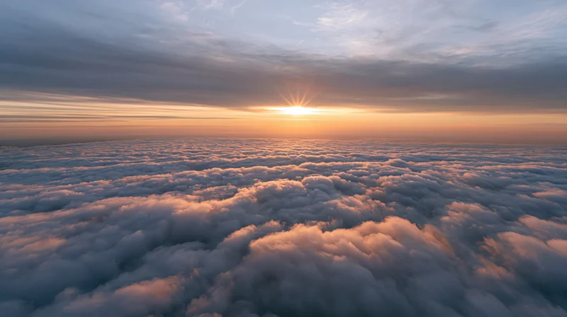 Aerial view of dense clouds at sunset above the horizon