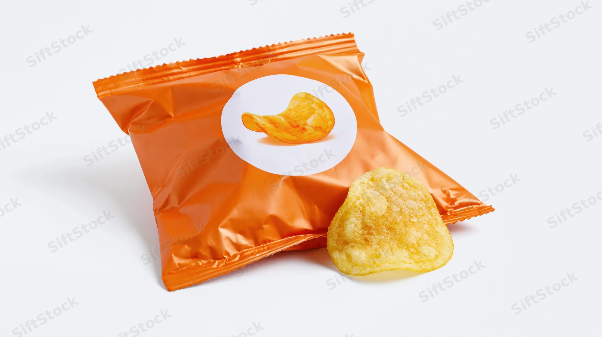 Orange foil snack bag with circular white label showing chip illustration, one chip beside it on white background