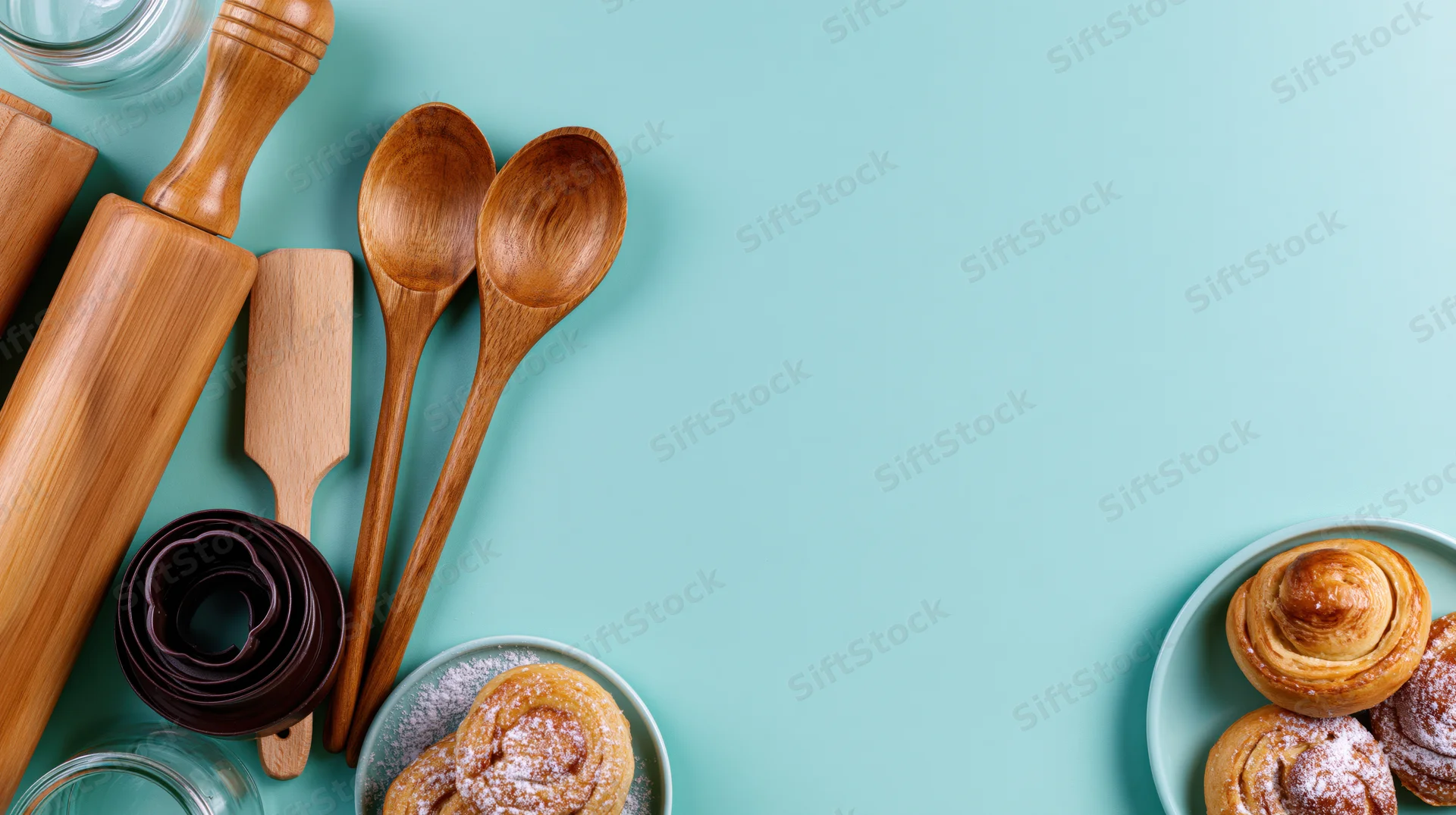 Baking tools and pastries arranged along the left and bottom edges on a teal surface
