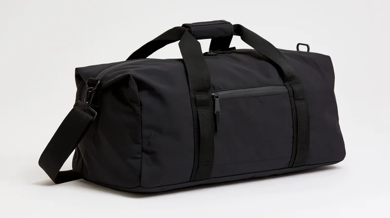 Black nylon duffel bag with top handles and front zipper pocket on white background