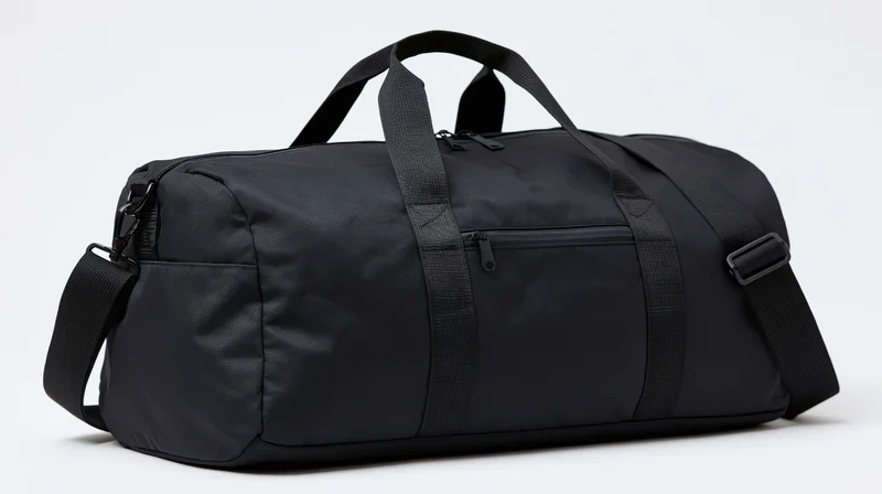 Black nylon duffle bag with zippered front pocket and adjustable strap on white background