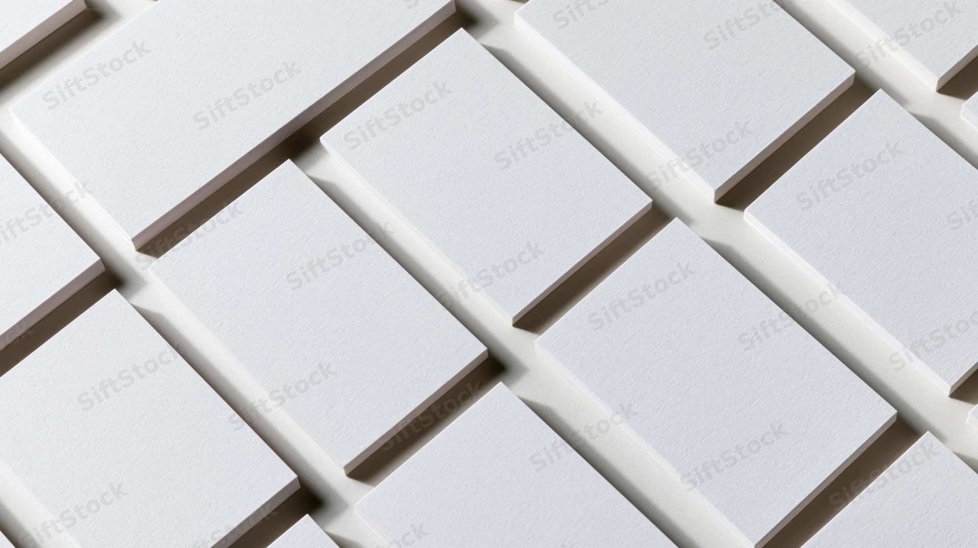 Blank white business cards arranged in a diagonal grid pattern