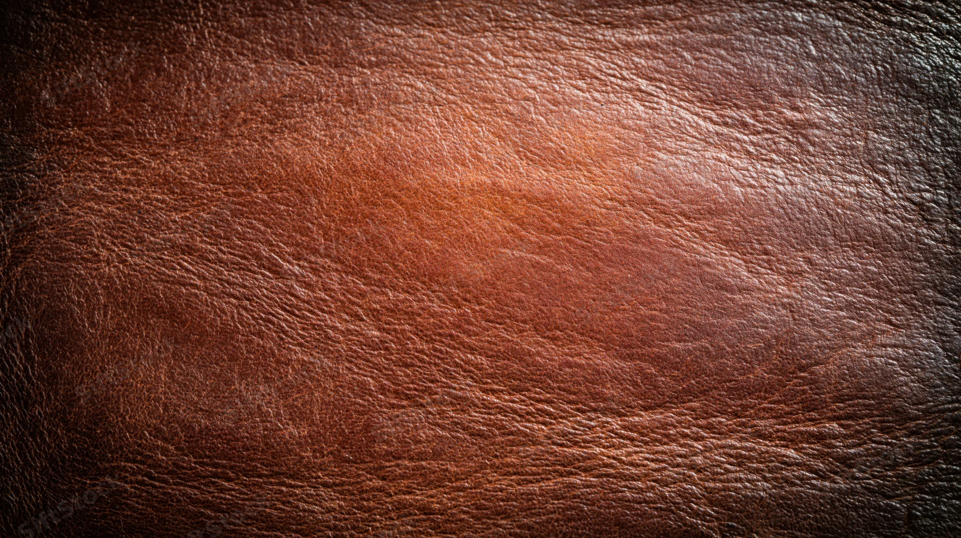 Close-up of aged full-grain leather surface with visible texture and grain pattern