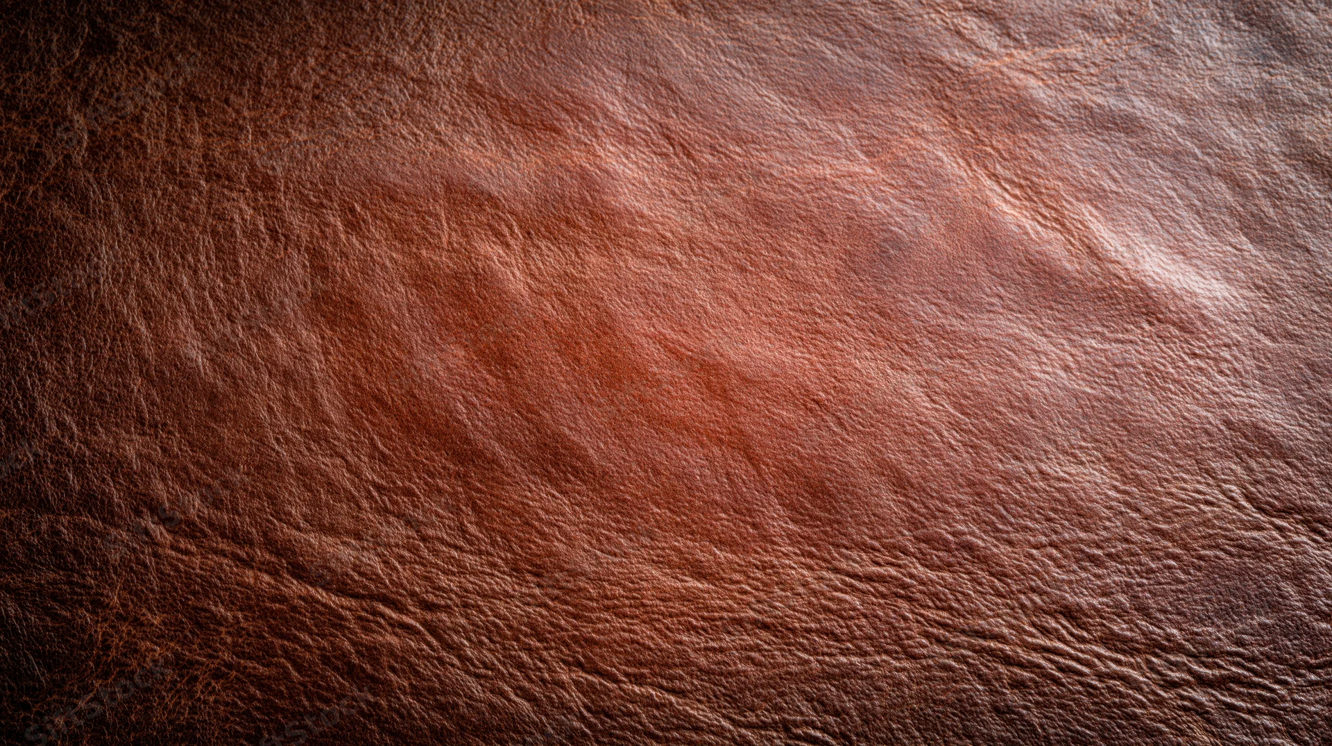 Close-up of aged full-grain leather surface with natural texture and creases