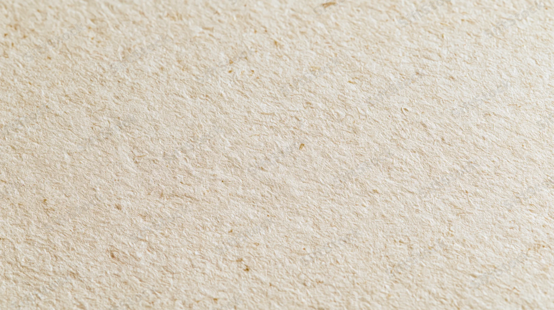 Close-up of recycled kraft paper surface with natural fiber texture filling the frame