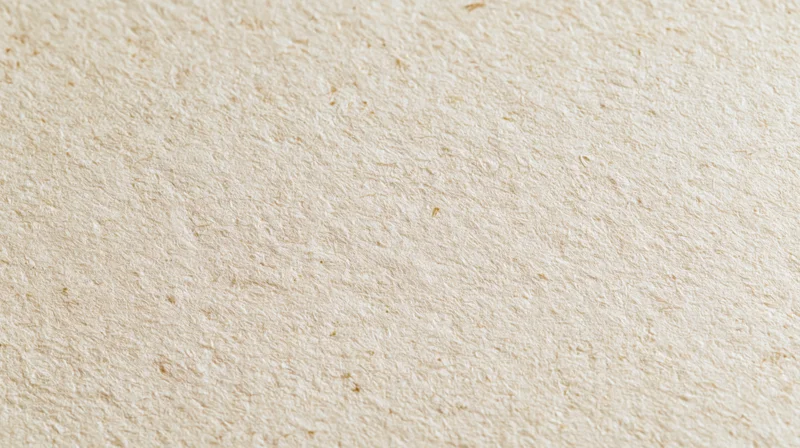 Close-up of recycled kraft paper surface with natural fiber texture filling the frame