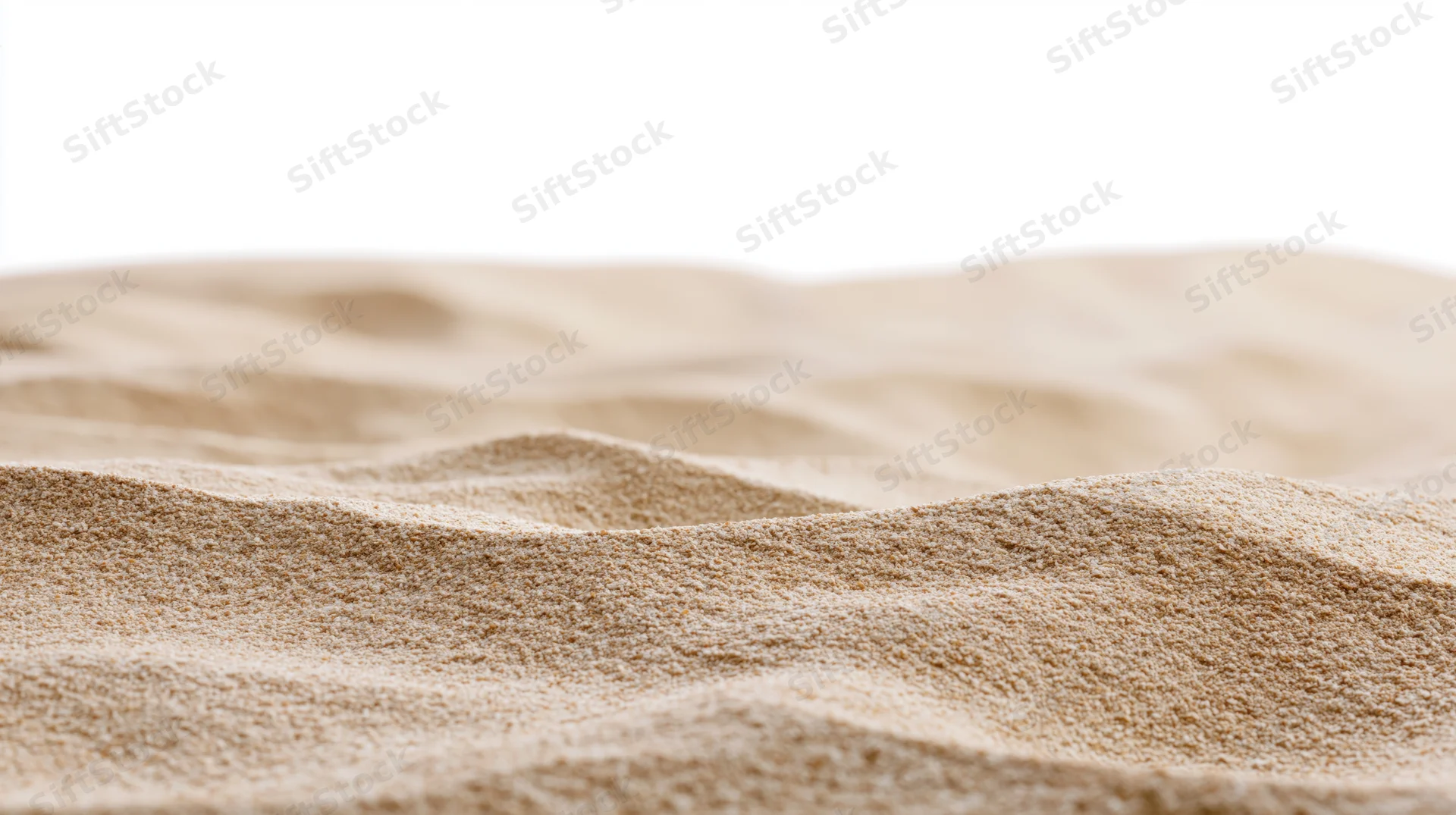 Close-up of dry beach sand with wind-formed ripples and undulations, isolated on white background