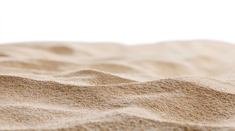 Close-up of dry beach sand with wind-formed ripples and undulations, isolated on white background