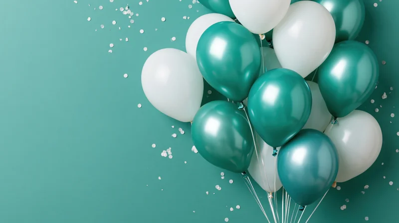 Cluster of teal metallic and white balloons with scattered confetti on teal background