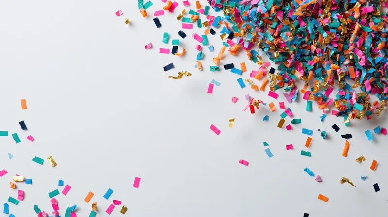 Colorful paper confetti scattered across a white background