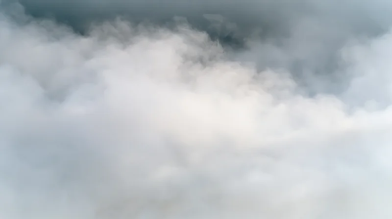 Dense white and grey smoke filling the frame with soft swirling clouds and atmospheric haze