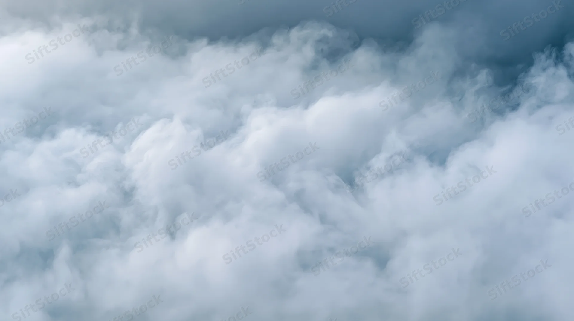 Dense white and grey smoke filling the frame in a swirling cloud formation