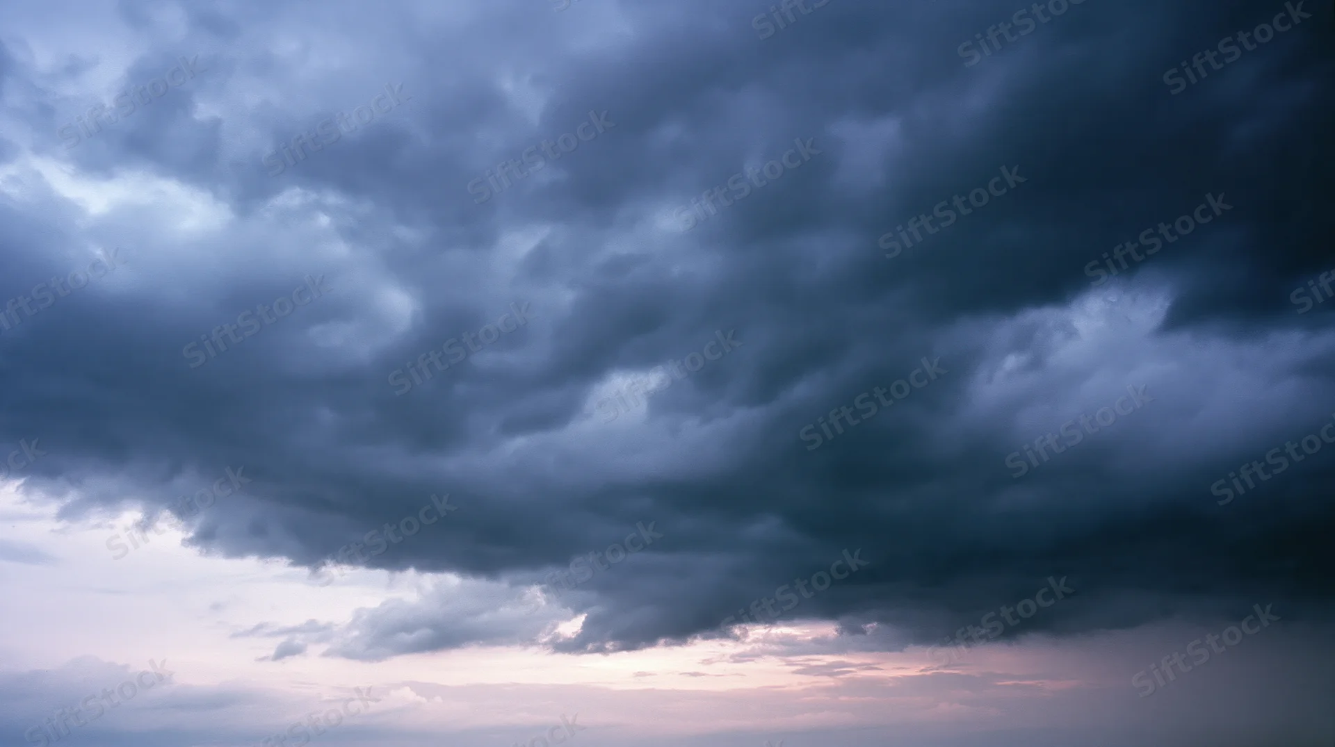 Dark storm clouds filling the sky at dusk