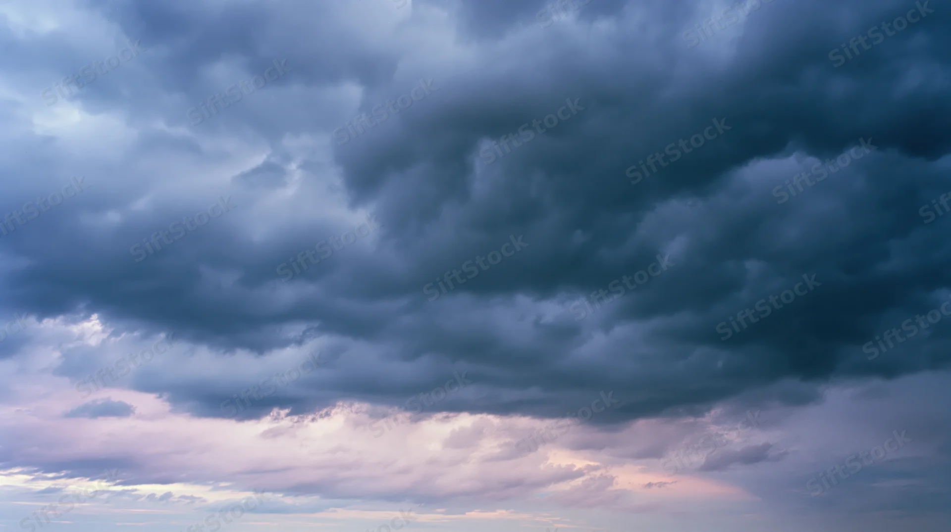 Dramatic stormy sky filled with dark cumulonimbus clouds at twilight