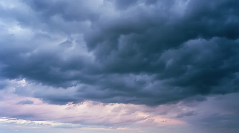 Dramatic stormy sky filled with dark cumulonimbus clouds at twilight
