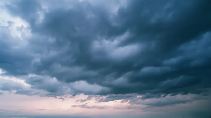 Dramatic stormy sky filled with dark cumulonimbus clouds at twilight