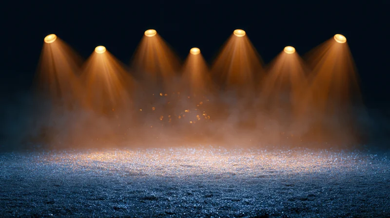 Stage floor covered in blue glitter dust under warm spotlights with haze
