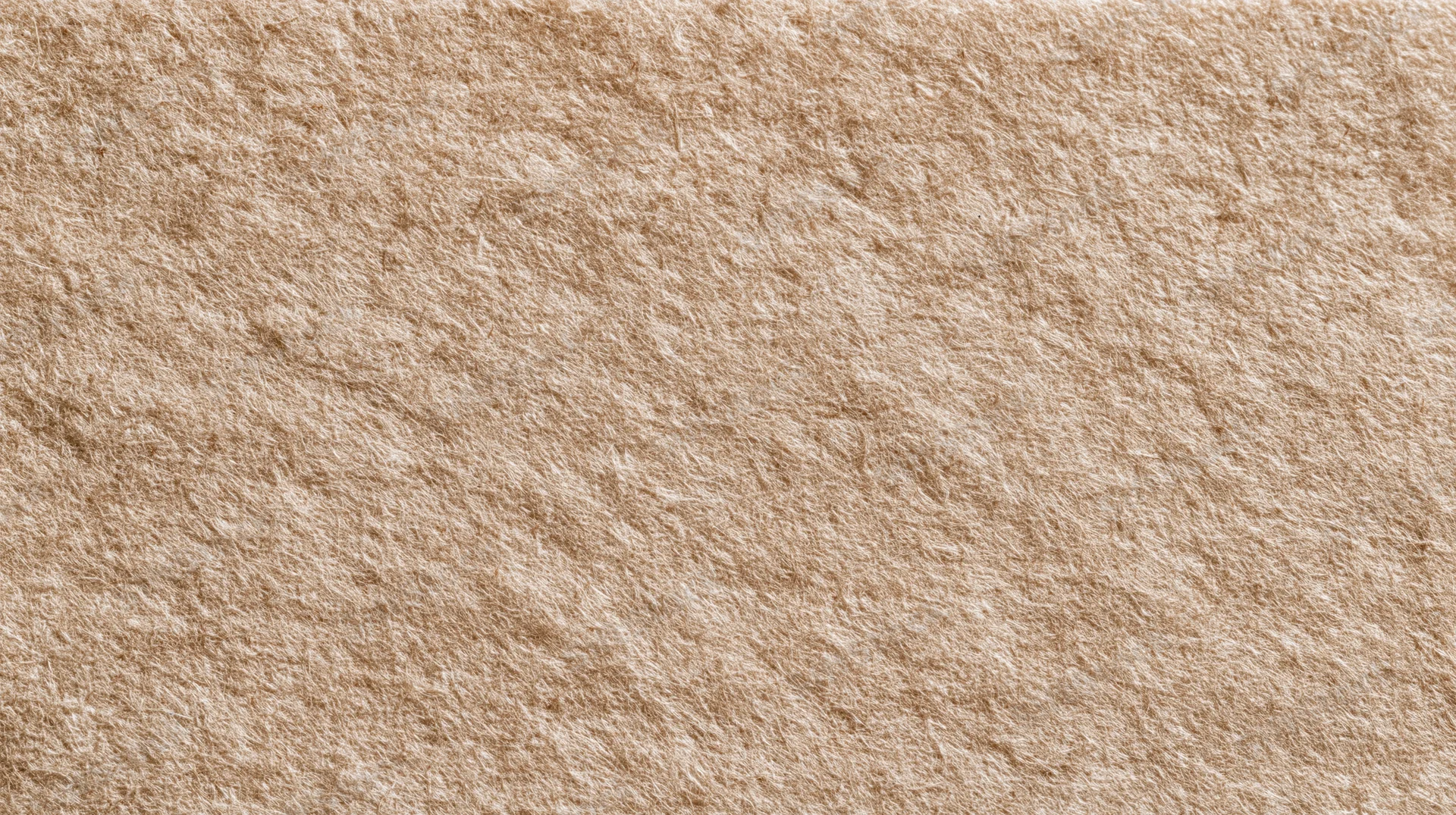 Close-up of unbleached kraft paper surface showing natural fiber texture