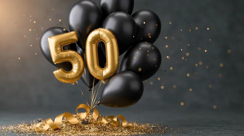 Gold foil number 50 balloons tied with black balloons and ribbons on a glittery surface with confetti