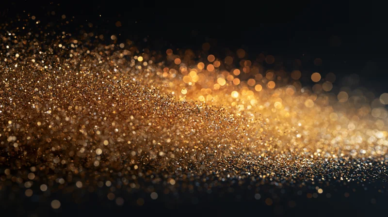 Golden glitter particles scattering in motion against a dark background