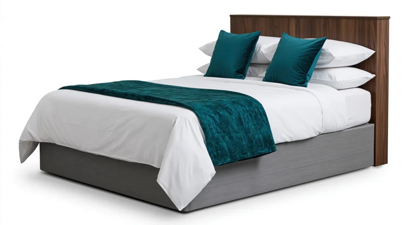 Double bed with white linens and teal accents against plain white background