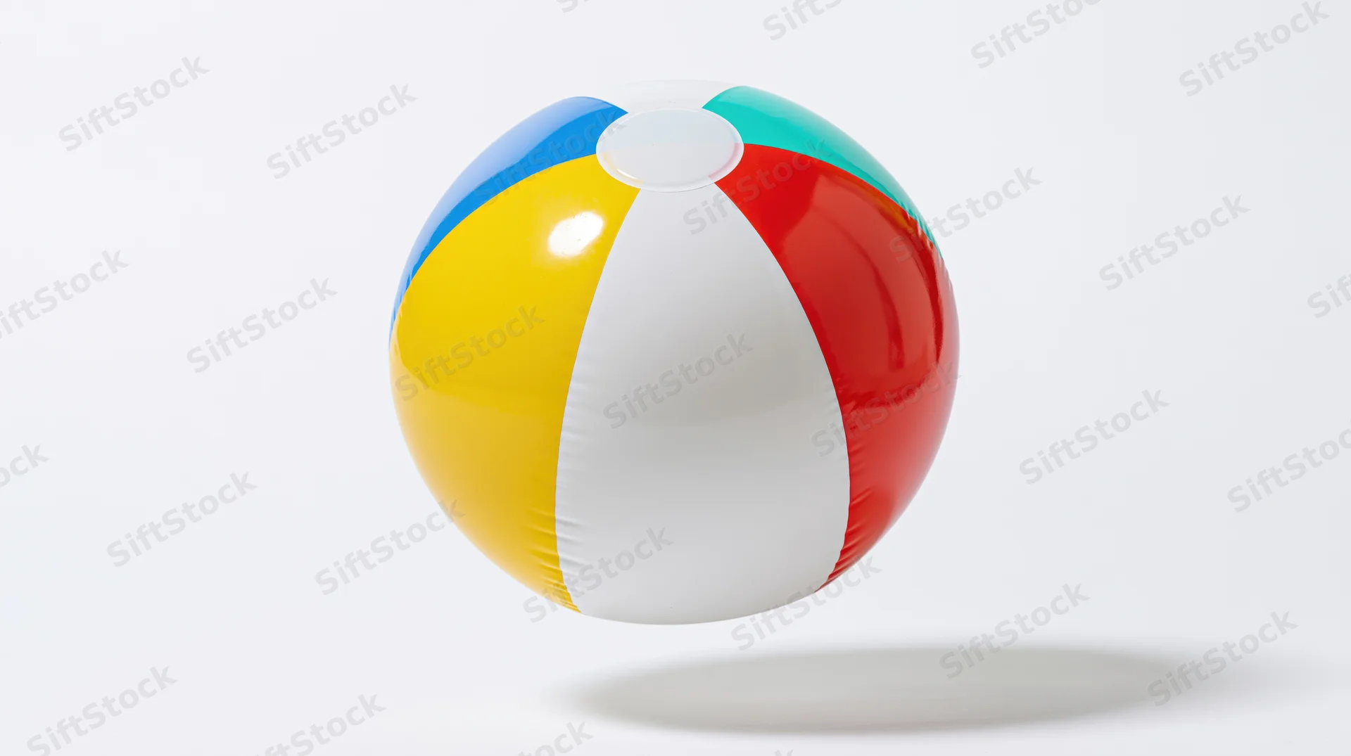 Inflatable beach ball with colorful panels floating against white background