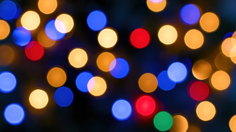 Blurred colorful party lights in a dark setting creating a festive bokeh effect