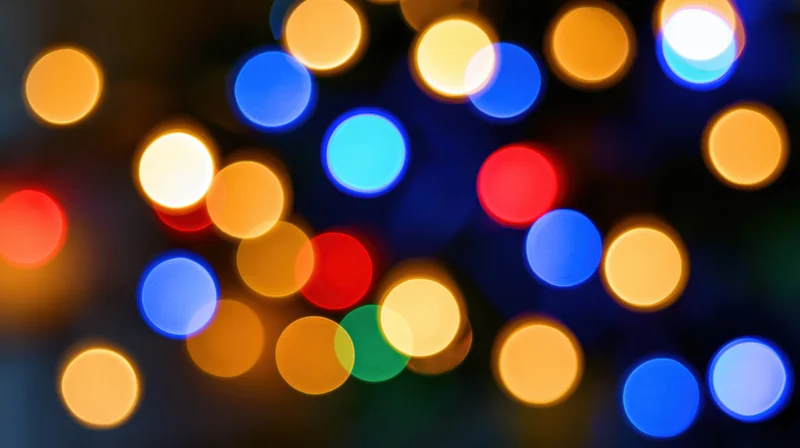 Blurred colorful lights in a festive pattern against a dark background