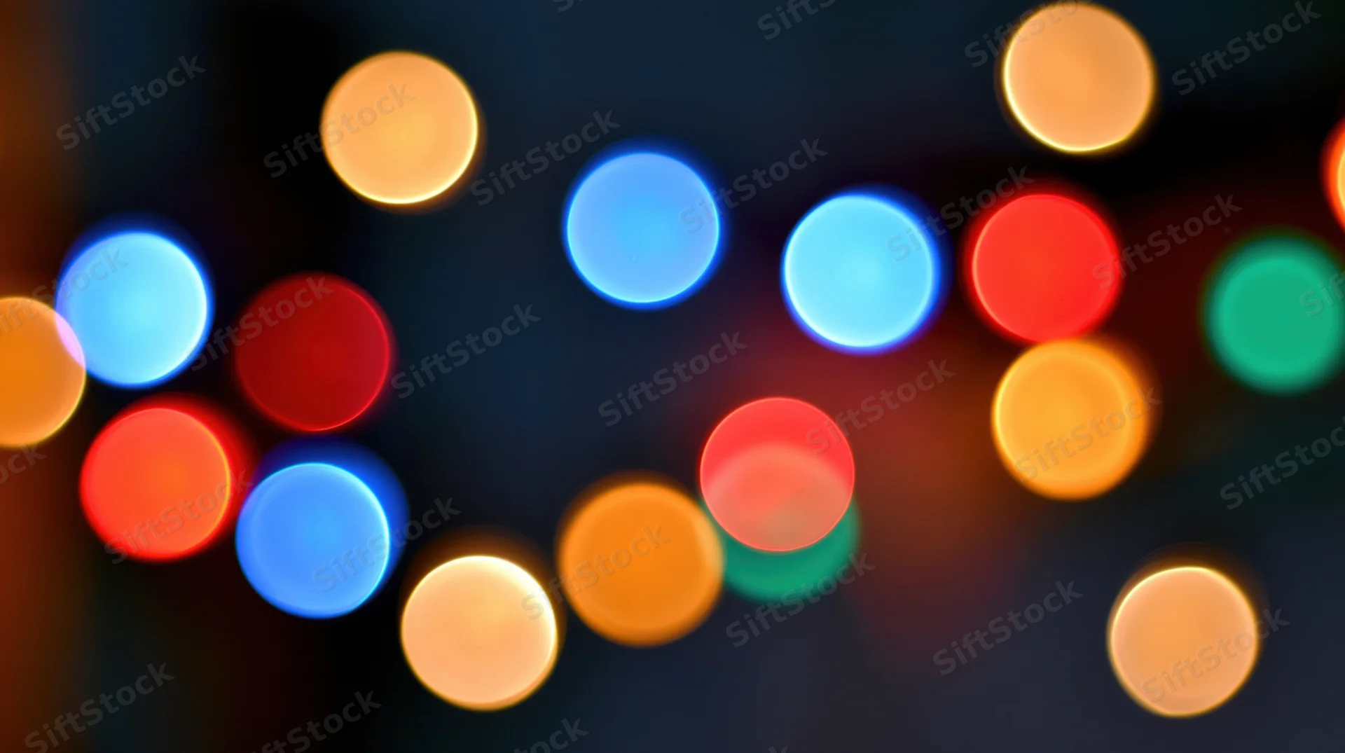Blurred colorful lights in a dark setting creating a festive bokeh effect