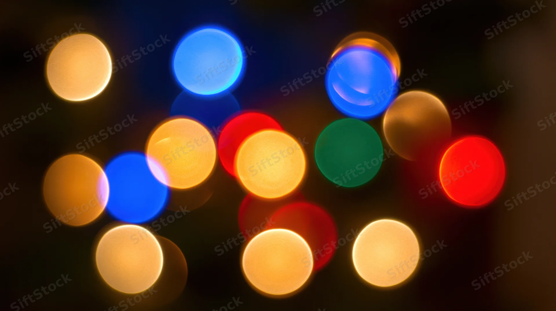 Blurred colorful lights in bokeh effect against dark background