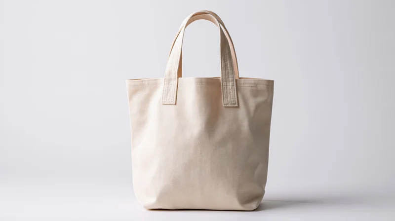 Cream canvas tote bag standing upright against white background